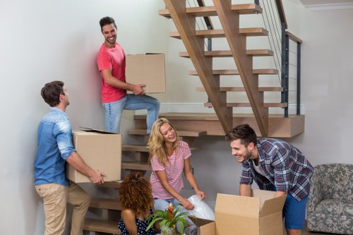 Driver handling household items during a van transport job