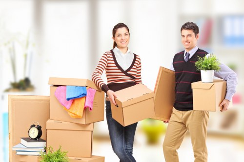 Professional movers handling furniture in a local flat move