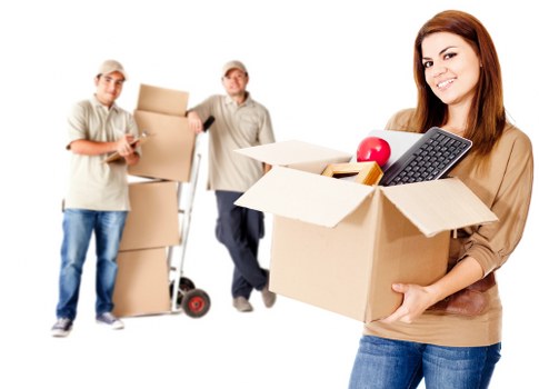 Worker assessing a van load and securing items for transport