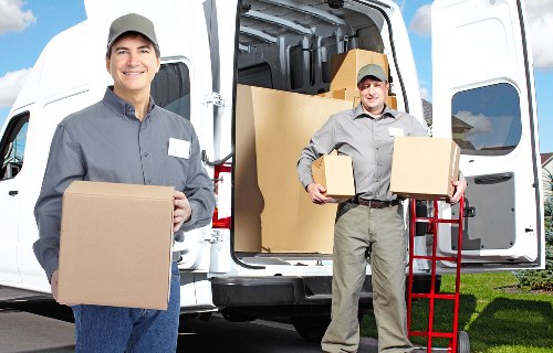 Careful loading of household items during a St Giles removals service