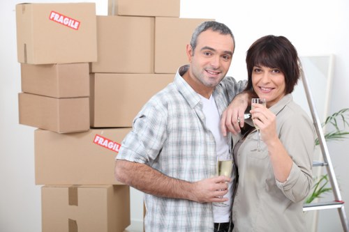 Local removals van helping with furniture loading in central London